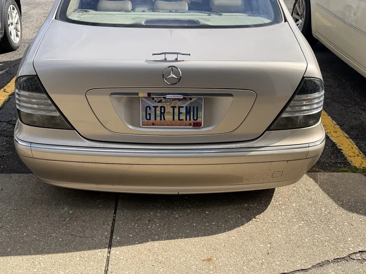 Actual rear view of Allison in a parking lot, showing the small trunk spoiler and GTR TEMU plate.