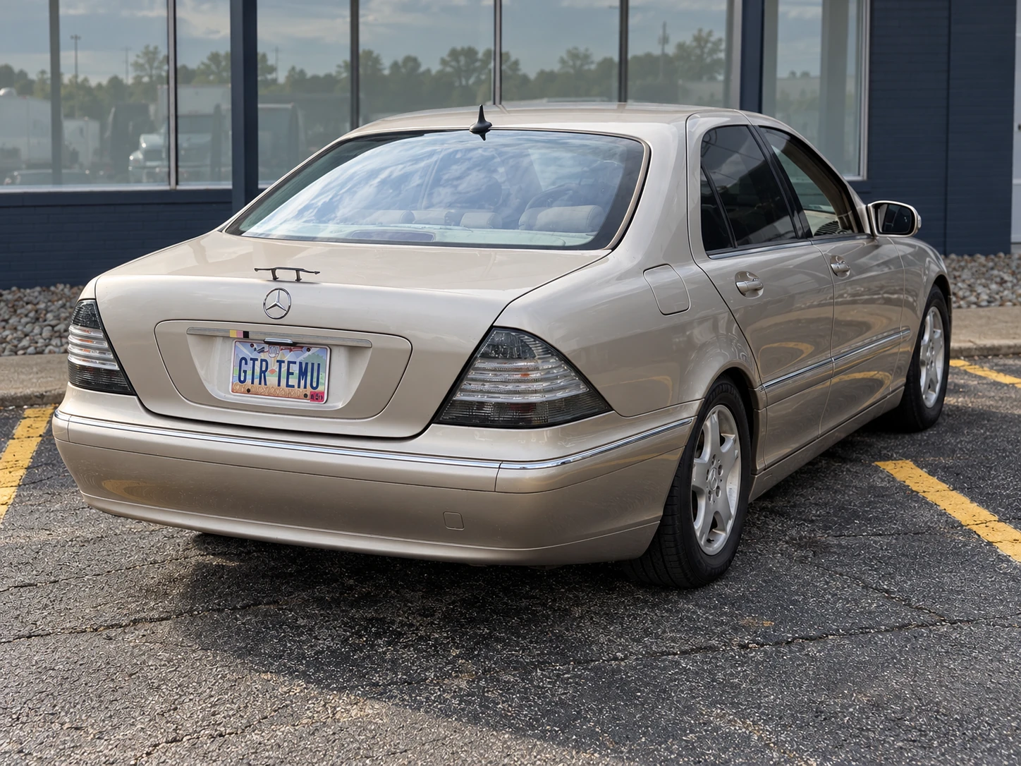 Rear three-quarter edited view of Allison showing its miniature trunk wing in a parking lot.
