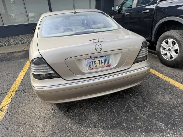 Actual rear view of Allison in a parking lot, showing the miniature spoiler and GTR TEMU plate.