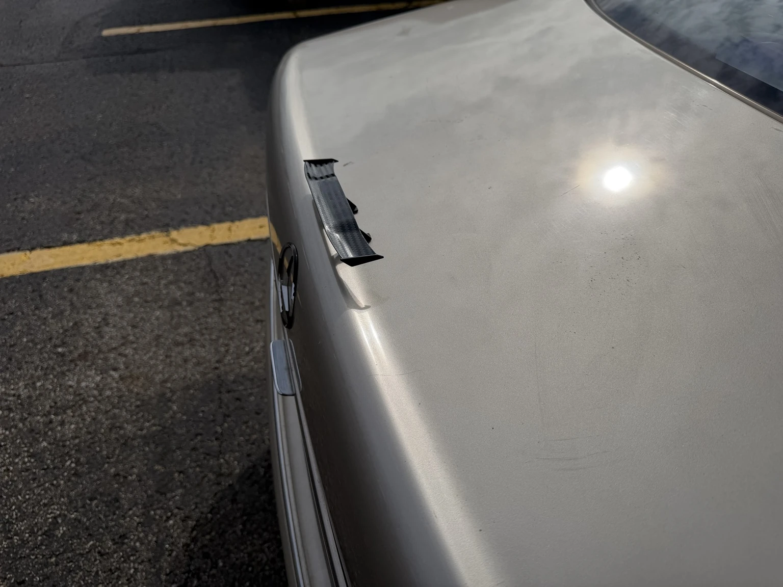Actual close-up of Allison’s champagne-gold trunk lid and miniature spoiler.