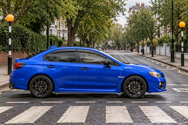 Garrett’s blue 2016 Subaru WRX. An imagined photoshoot beside the Abbey Road zebra crossing near Grove End Road, London, England.
