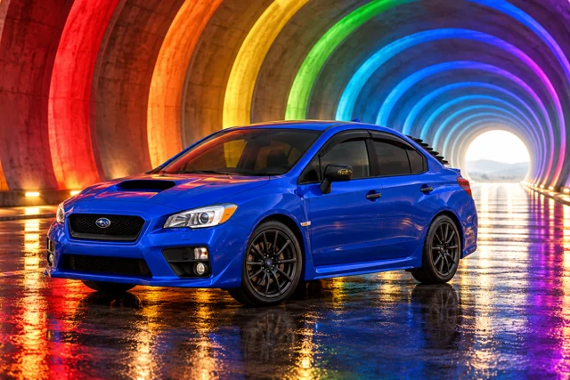 Garrett’s blue 2016 Subaru WRX. Architectural rings of the full rainbow recede through a monumental tunnel around the blue WRX.