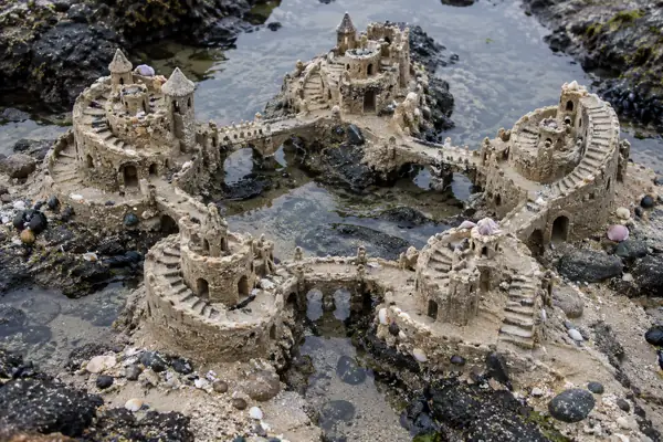 Five spiral sand forts in a tidepool.